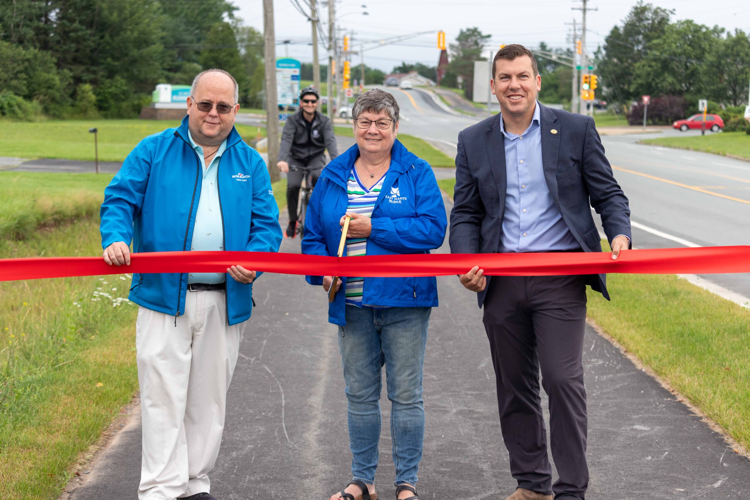 Left to right: MLA John A. MacDonald, Warden Eleanor Roulston and MP Kody Blois cut the ribbon to officially open the Active Transportation pathway.