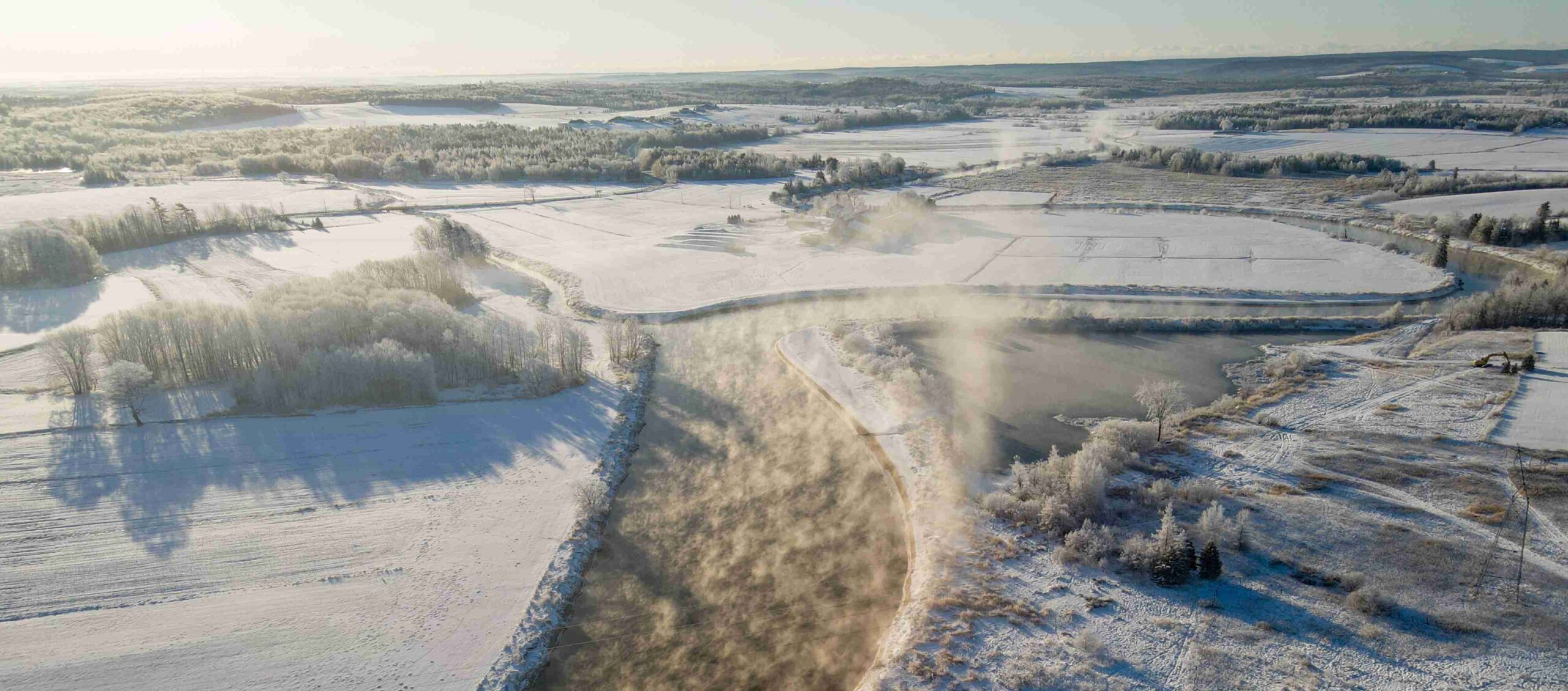 Shubenacadie River winding through snow covered fields on a frosty morning